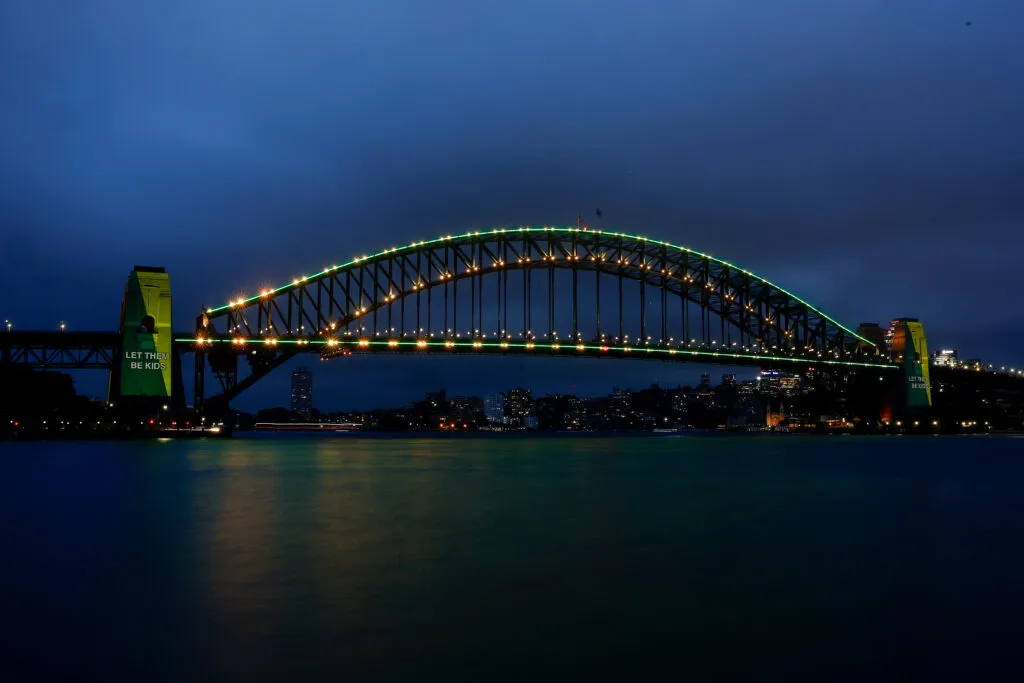The Sydney Harbour Bridge lit to mark the start of Australia’s under-16 social media ban