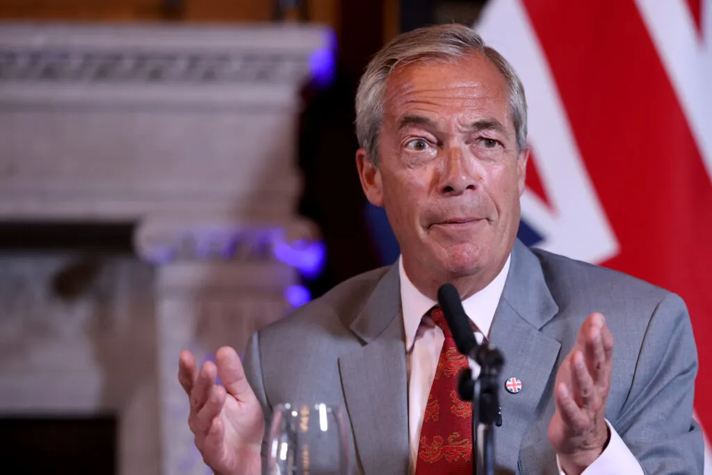 Nigel Farage at a press event, looking resolute